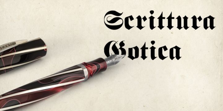 Una penna stilografica su pergamena con la scritta 'Scrittura gotica'.