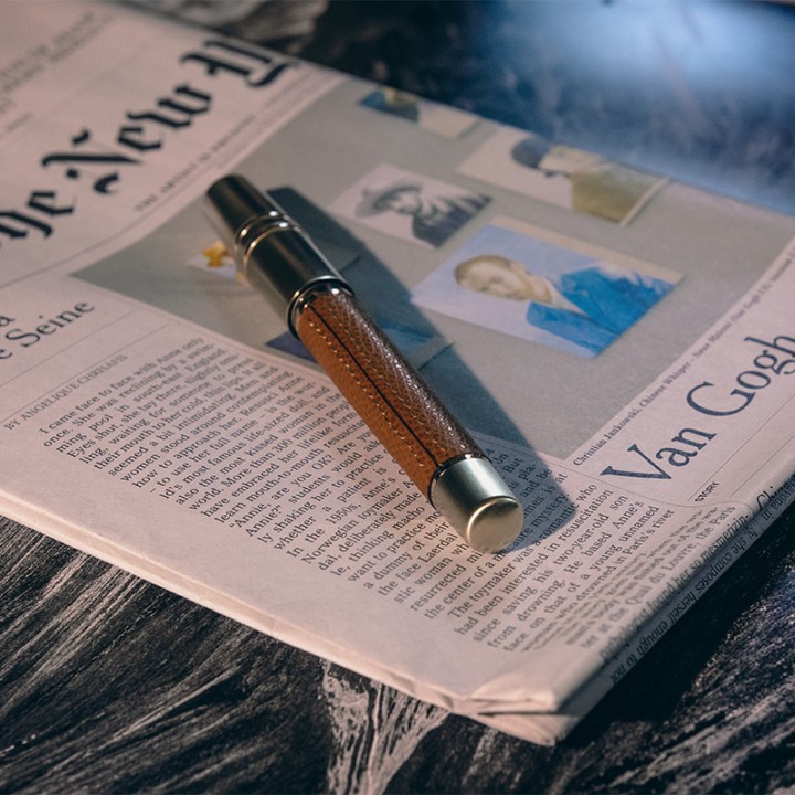 Homo Sapiens Dual Touch Cognac pen resting on a newspaper