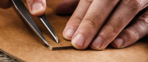 Artisan hands working on leather